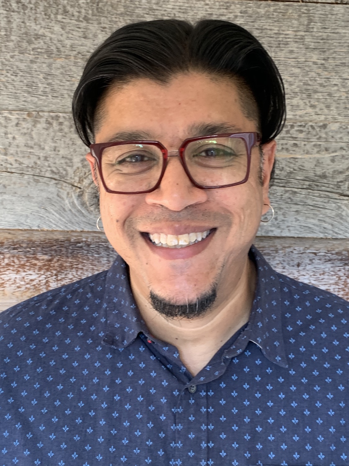 Arun smiles boradly at the camera